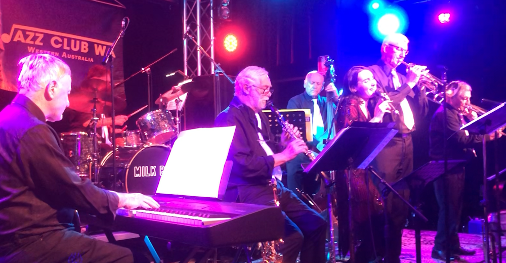 Image contains a seven piece live band